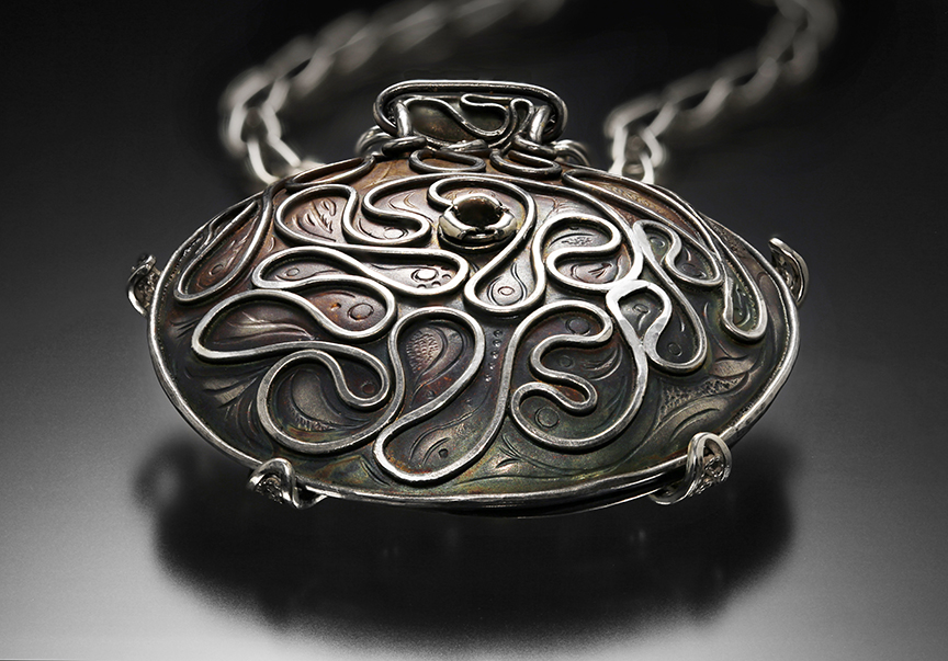 Relativity Navigator (back view), Rotating Russian filigree, chased, granulation, and gilt pendant on a Roman chain by Victoria Lansford; photo by Pat Vasquez-Cunningham