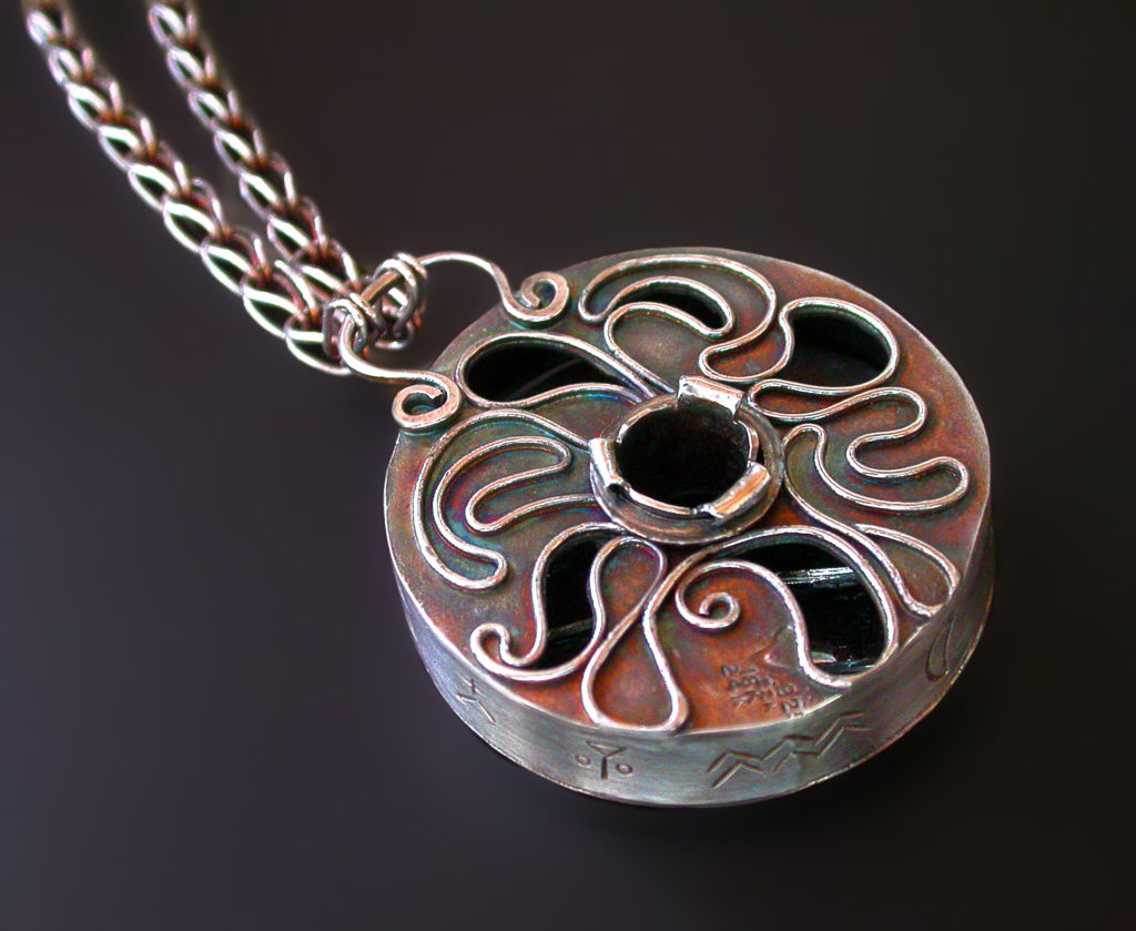 Uncertainty Principle (back), Filigree backed pendant on a handwoven chain by Victoria Lansford