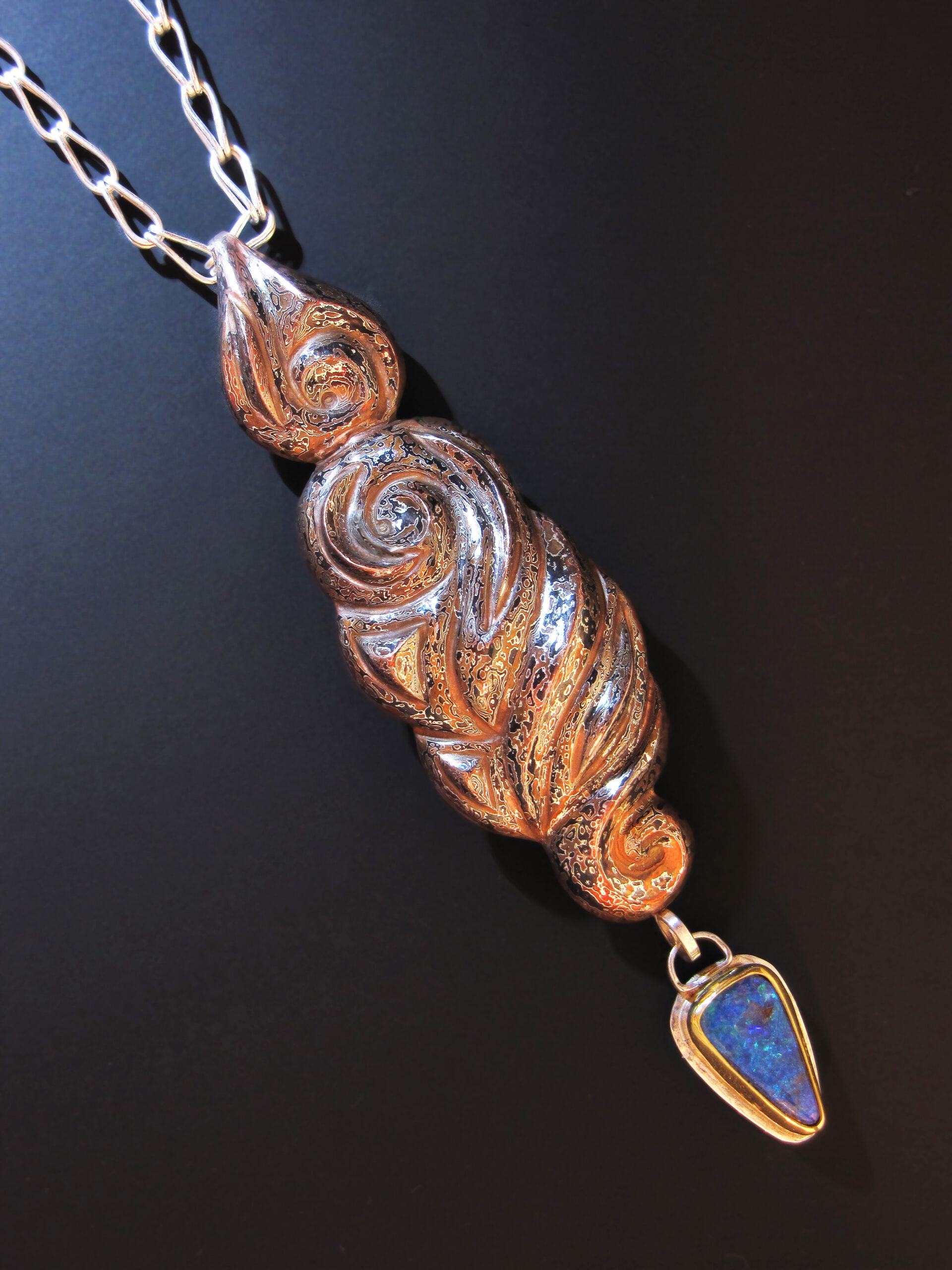 Allahoudine, Eastern repoussé pendant from dimensionally patterned mokume gane, Roman chain, 2012; Sterling, copper, shibuichi, 22k gold, fine silver, Koroit opal