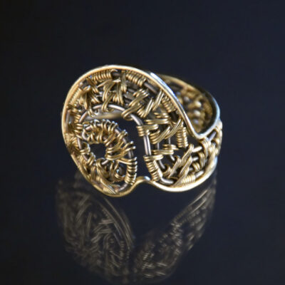 Ariadne's Entrance III, 22k gold woven in the double sumac pattern over an oxidized sterling warp and framed in 18k gold