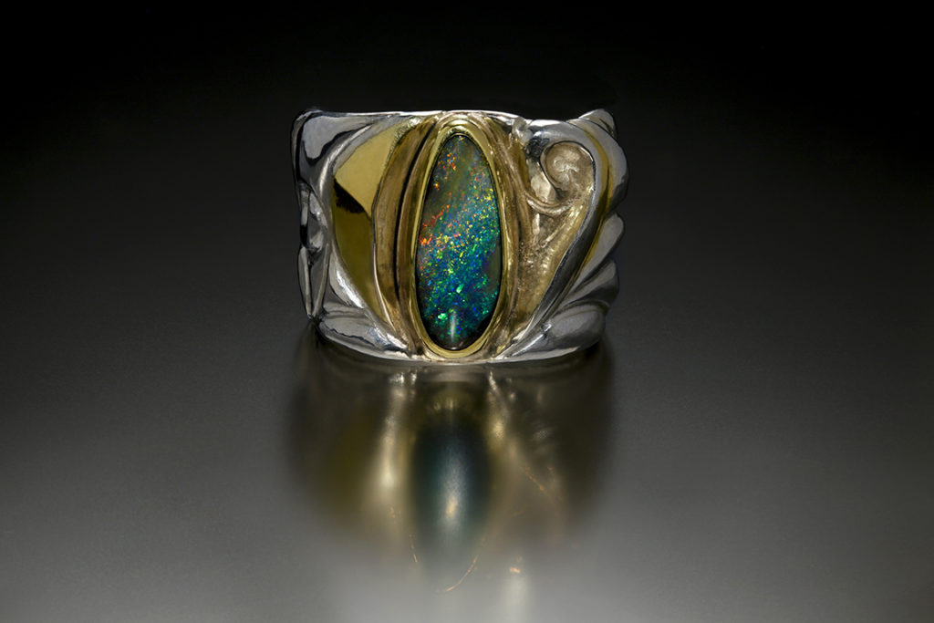 Enveloped IV, Eastern repousse and kum boo ring with Koroit opal by Victoria Lansford; photo by Pat Vasquez-Cunningham