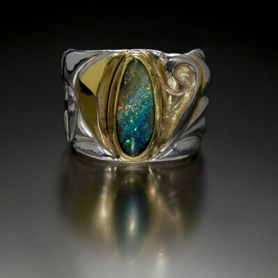 Enveloped IV, Eastern repousse and kum boo ring with Koroit opal by Victoria Lansford; photo by Pat Vasquez-Cunningham