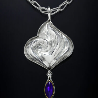 Marida Blue IV, Eastern repousse and engraved pendant by Victoria Lansford; photo by Pat Vasquez-Cunningham
