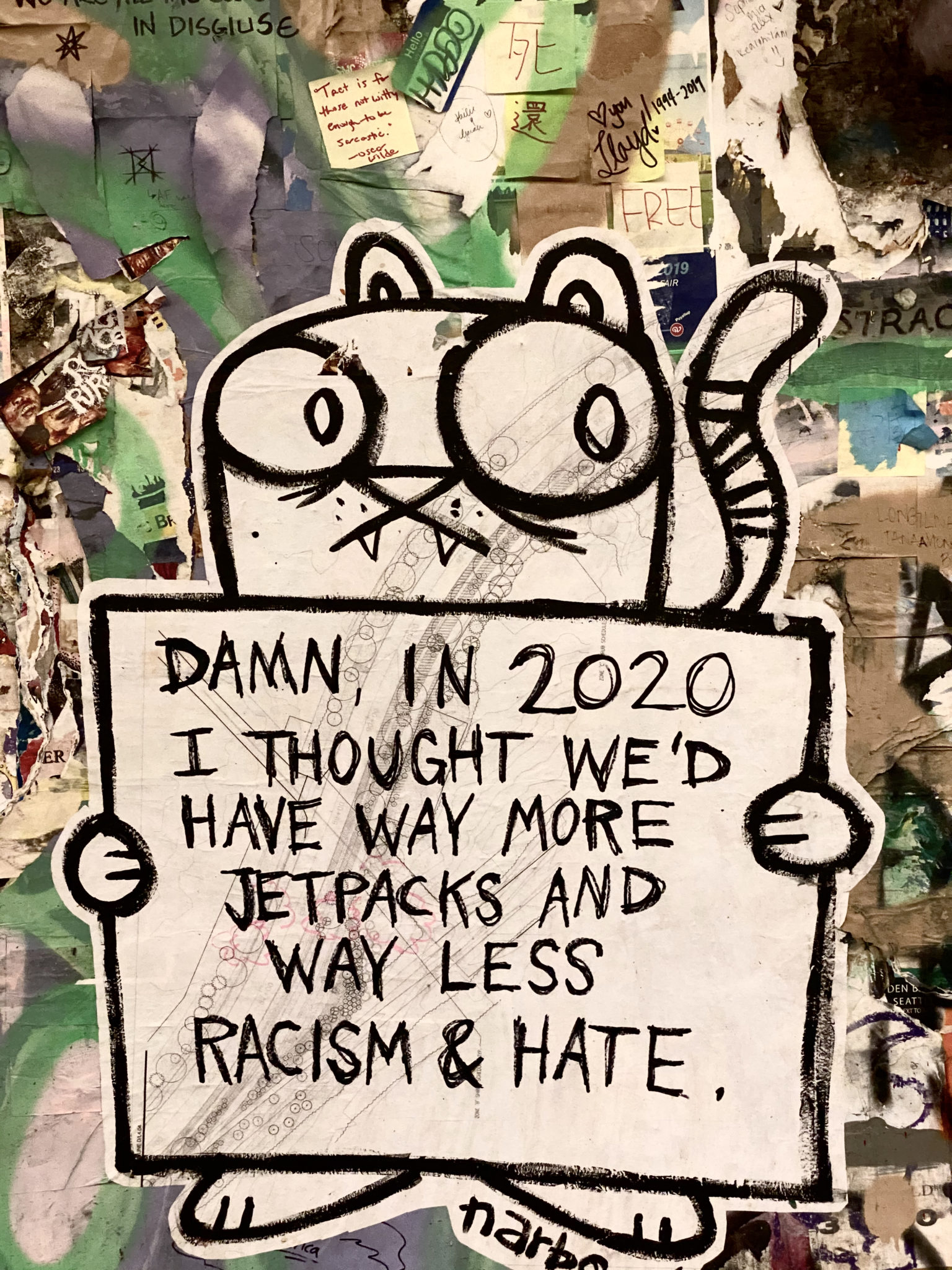 Graffiti in Seattle near Pikes Market that says "Damn, in 2020 I thought there wold be way more jetpacks and way less racism and hate," photo by Victoria Lansford