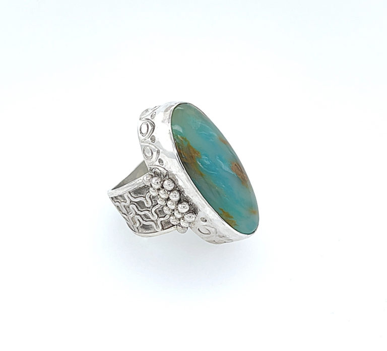 Capella, a "big beautiful bezel" ring with a wire granulation shank