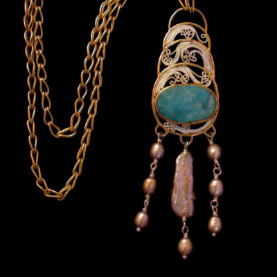 Delicate filigree fills the crescent phases, surrounding a naturally formed chrysocolla drusy, framed in 18K and 22K gold with a fall of naturally golden Biwa and baroque pearls and suspended from a hand-fused loop-in-loop chain.