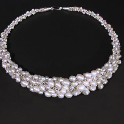 Genuine freshwater and Biwa pearls symbolized the pebbles of a beach in this tapered necklace, continuously handwoven of pure silver.