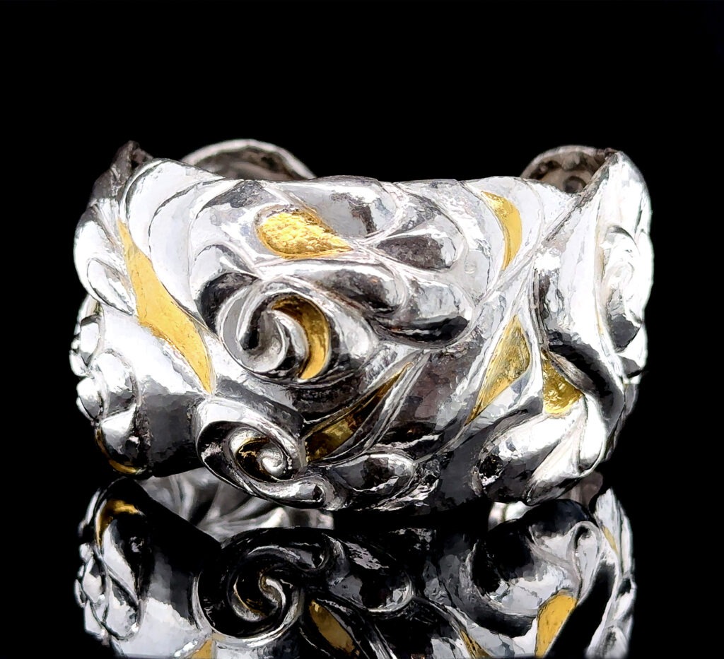 Masterfully crafted chased cuff bracelet, a testament to the beauty of metalsmithing