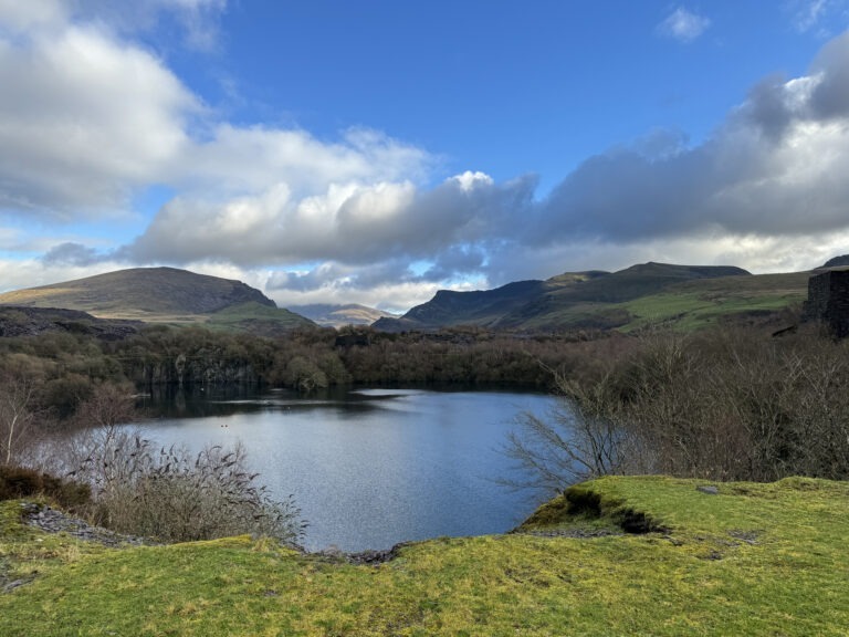 Yr Wyddfa (formerly known as Snowdon) peeking out of the clouds (center), viewed across the road from Rauni's workshop