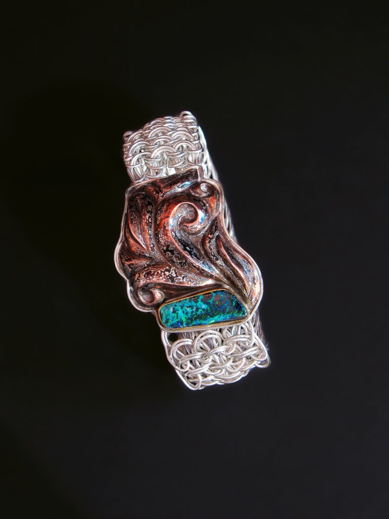 Foliage
Bottom right
Original pattern side weave mesh
chain bracelet with a clasp of Eastern
repoussé patterned mokume gane,
2012
Fine silver, sterling, copper, shibuichi,
22k gold, Koroit opal
7.25 x 1.375 x 0.5 in
Collection of Joele Connolly