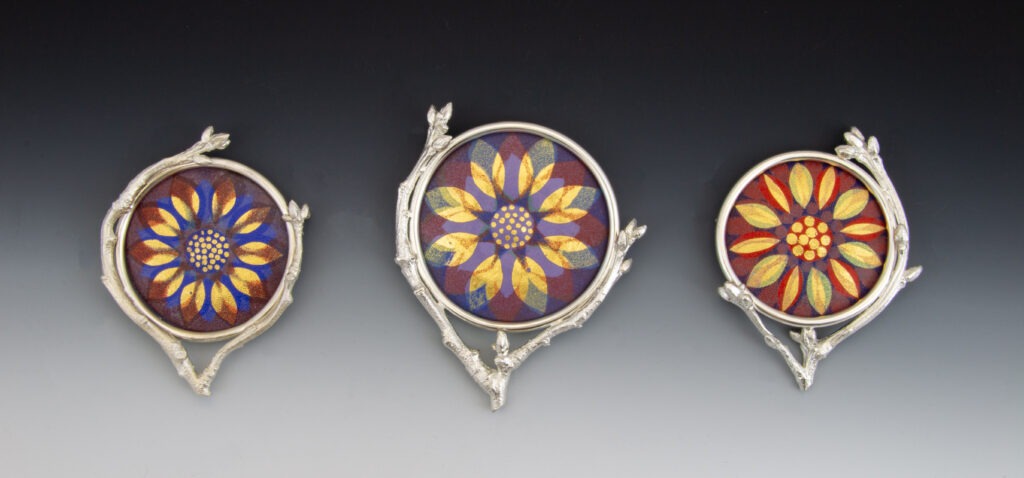 Mandala I, II, & III by Cynthia Eid, fabricated and enameled brooches, 2024; Argentium® silver, enamel